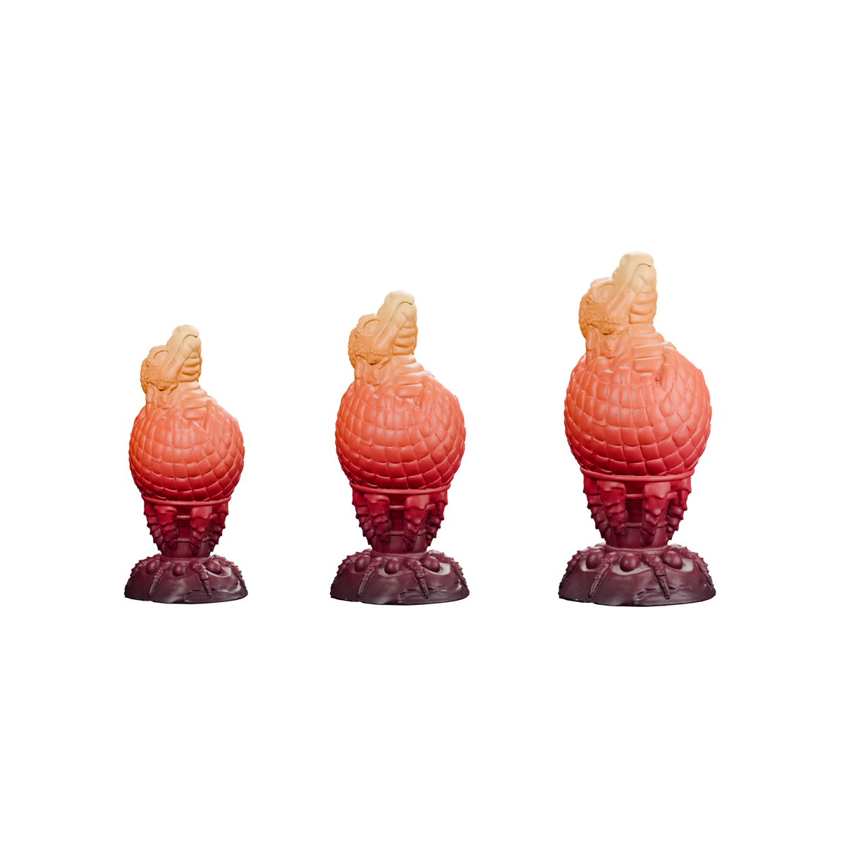 Huevo del Fuego · comparación proporcional Pequeño, Mediano y Grande, de izquierda a derecha. Render del mismo degradado burdeos, rojo, naranja y ámbar; sin fondo.