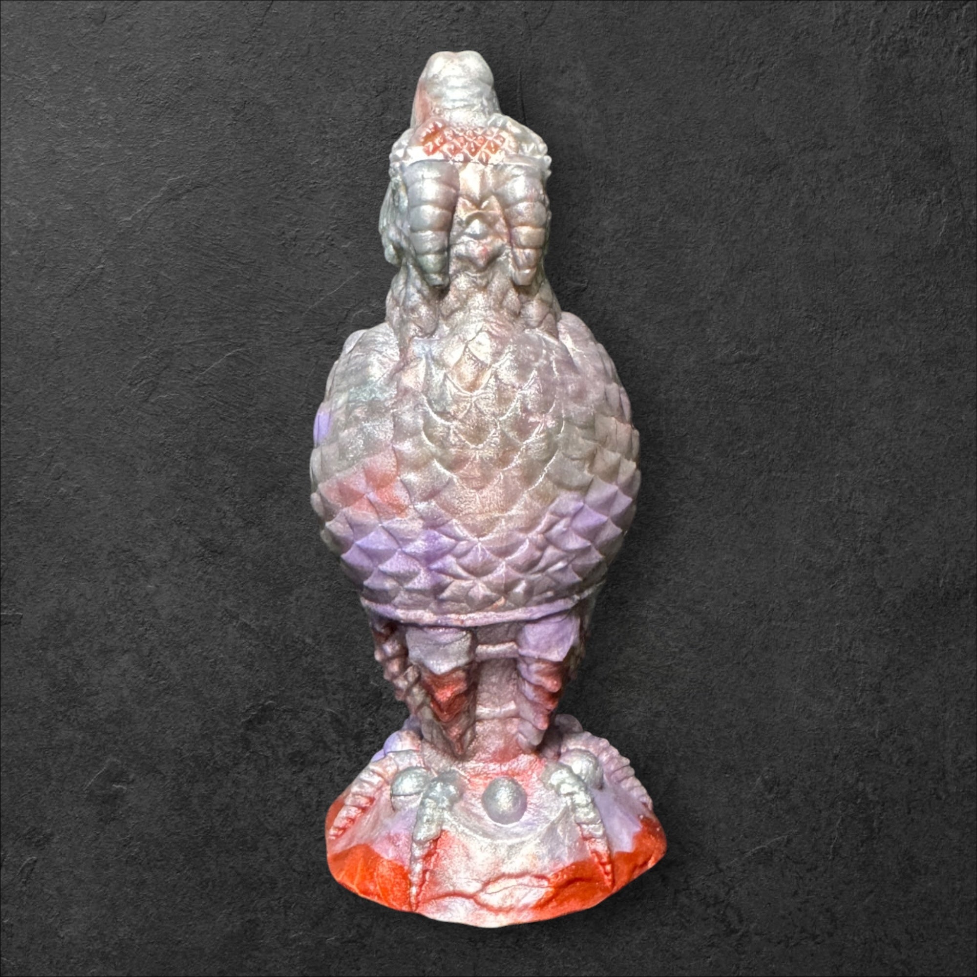 The Fire Egg Fantasy Plug. Textured dragon egg with hatching head at the tip and sculpted dragon claw safety base. Platinum Silicone by ClimaxLab.