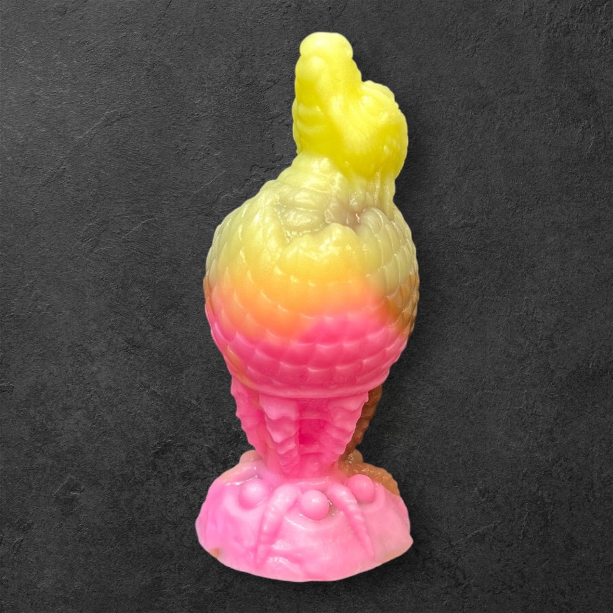 The Fire Egg Fantasy Plug. Textured dragon egg with hatching head at the tip and sculpted dragon claw safety base. Platinum Silicone by ClimaxLab.