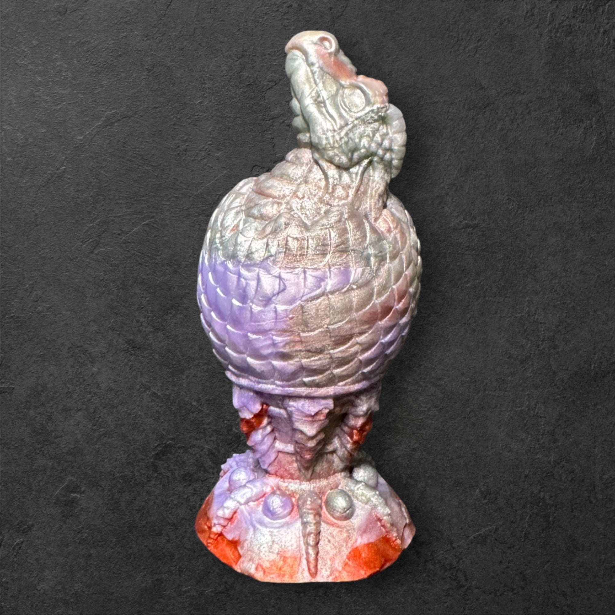 The Fire Egg Fantasy Plug. Textured dragon egg with hatching head at the tip and sculpted dragon claw safety base. Platinum Silicone by ClimaxLab.