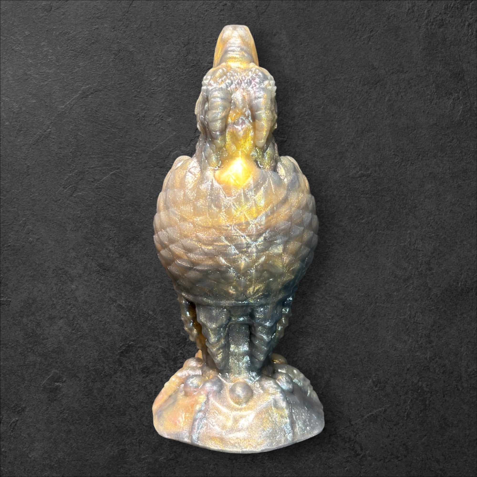The Fire Egg Fantasy Plug. Textured dragon egg with hatching head at the tip and sculpted dragon claw safety base. Platinum Silicone by ClimaxLab.