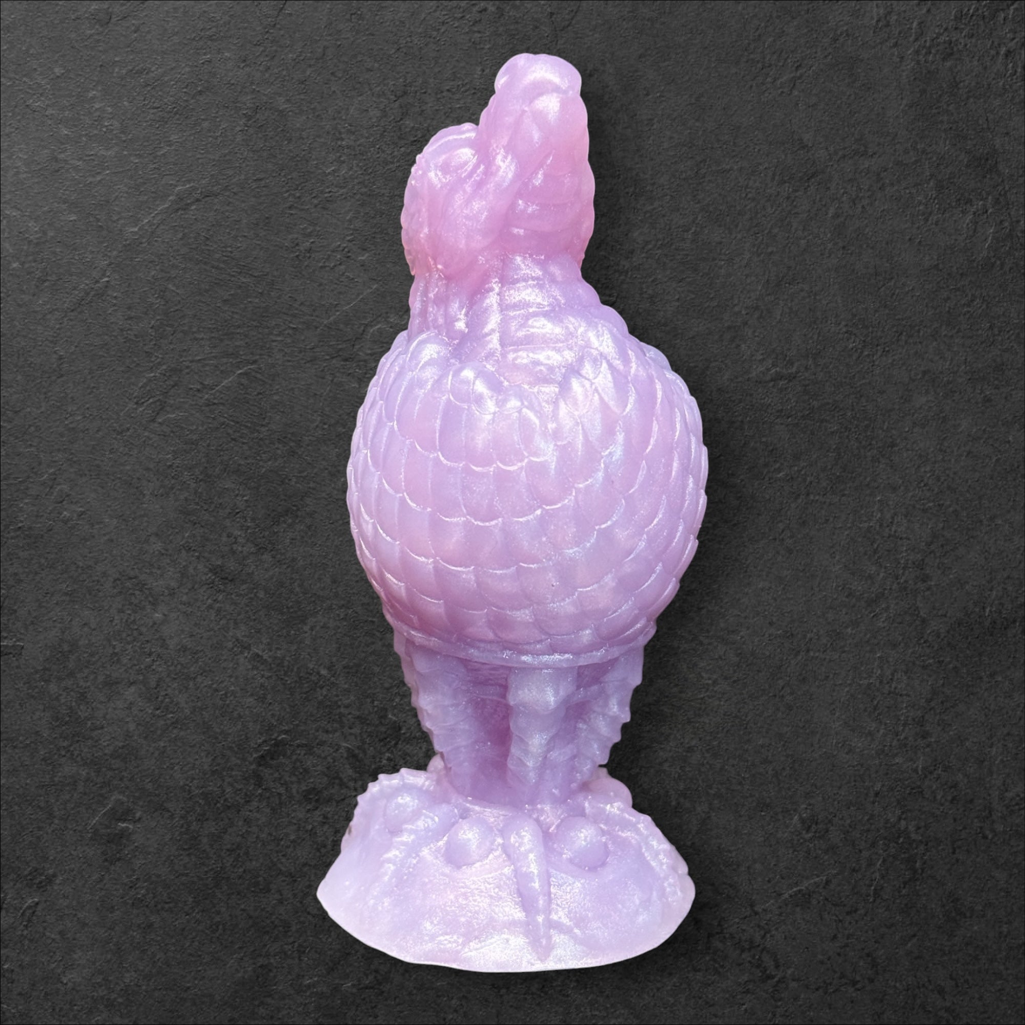 The Fire Egg Fantasy Plug. Textured dragon egg with hatching head at the tip and sculpted dragon claw safety base. Platinum Silicone by ClimaxLab.