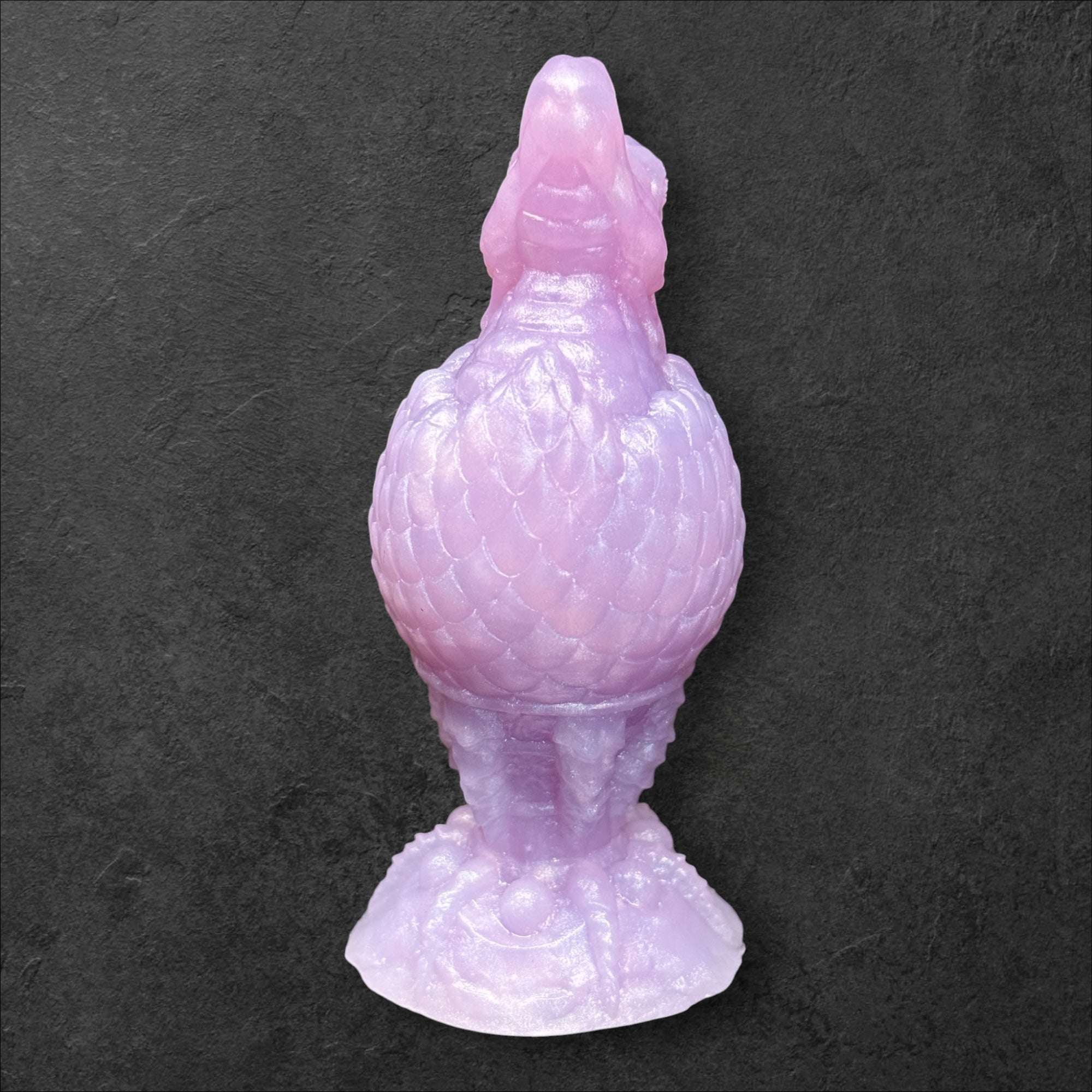 The Fire Egg Fantasy Plug. Textured dragon egg with hatching head at the tip and sculpted dragon claw safety base. Platinum Silicone by ClimaxLab.