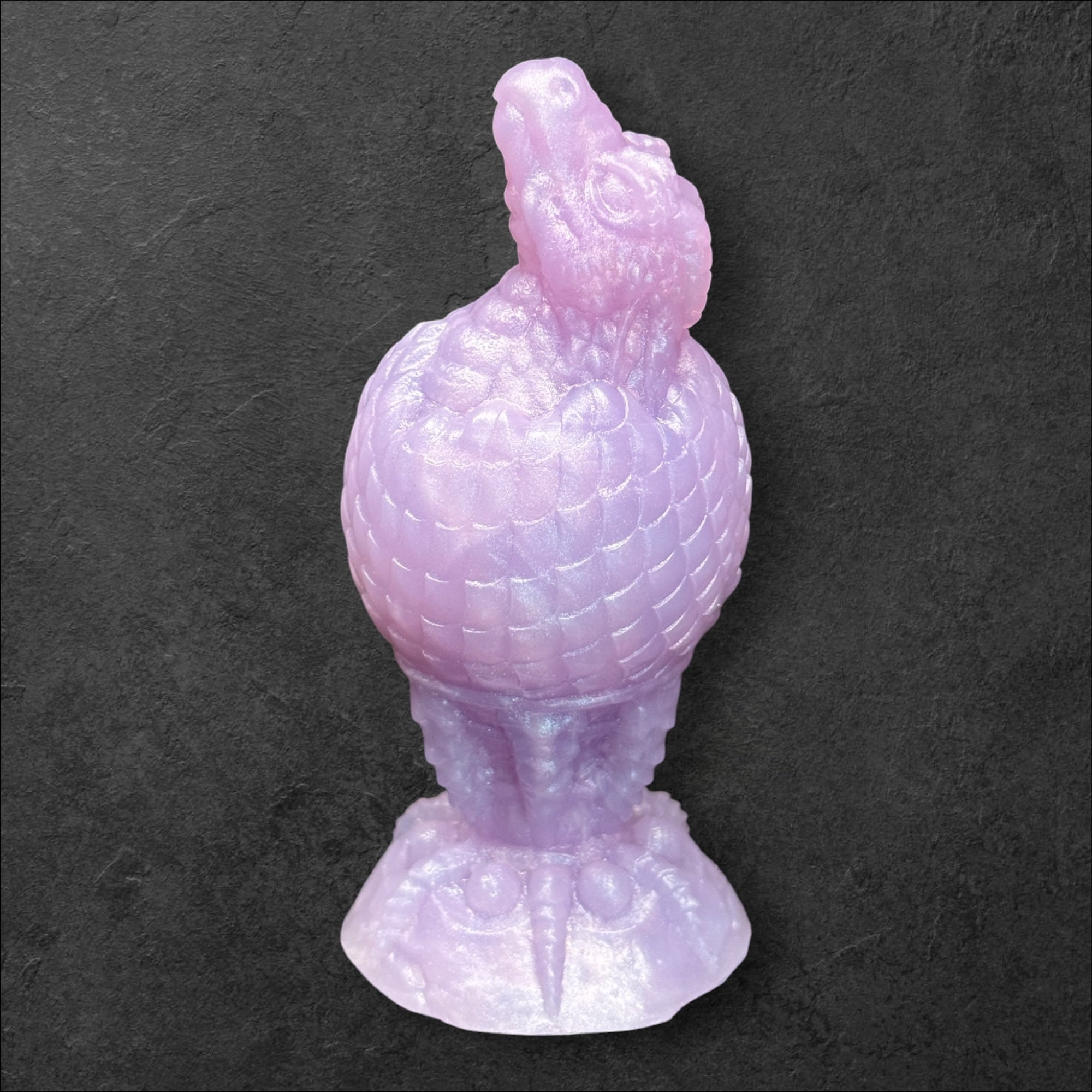 The Fire Egg Fantasy Plug. Textured dragon egg with hatching head at the tip and sculpted dragon claw safety base. Platinum Silicone by ClimaxLab.
