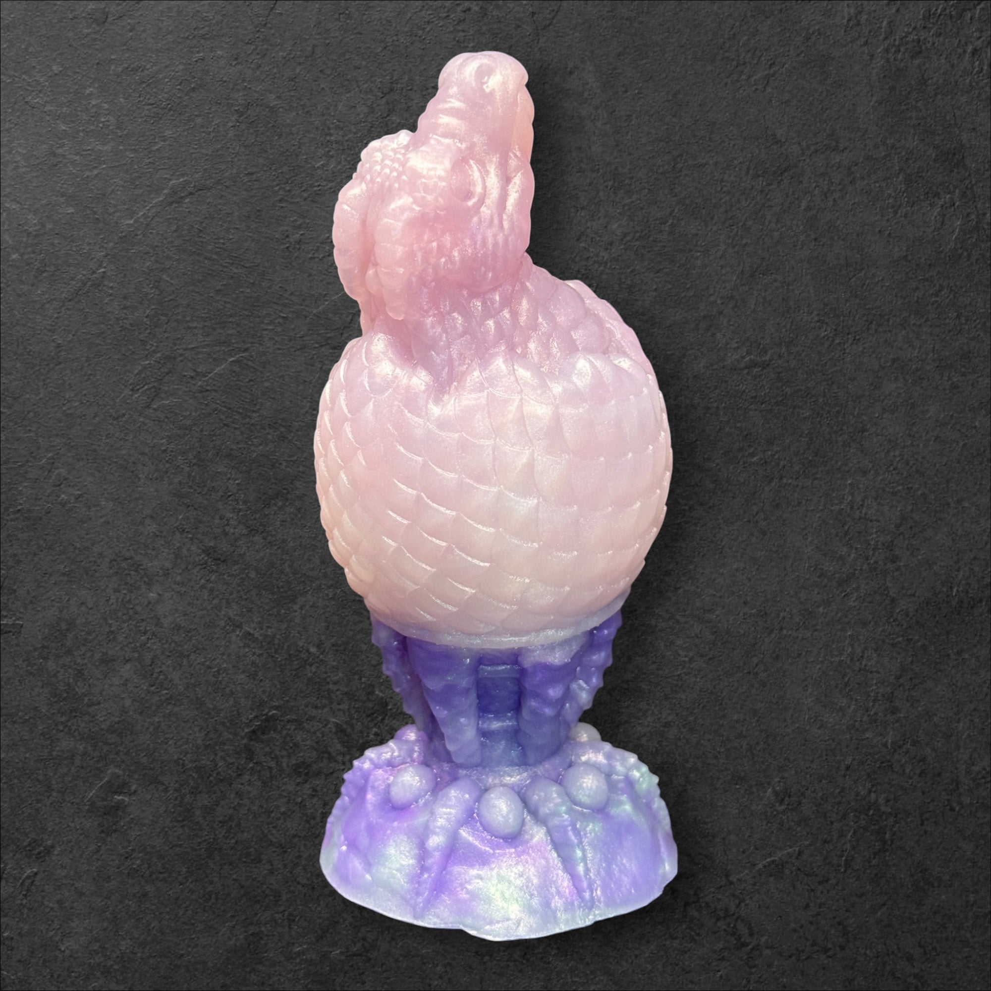 The Fire Egg Fantasy Plug. Textured dragon egg with hatching head at the tip and sculpted dragon claw safety base. Platinum Silicone by ClimaxLab.