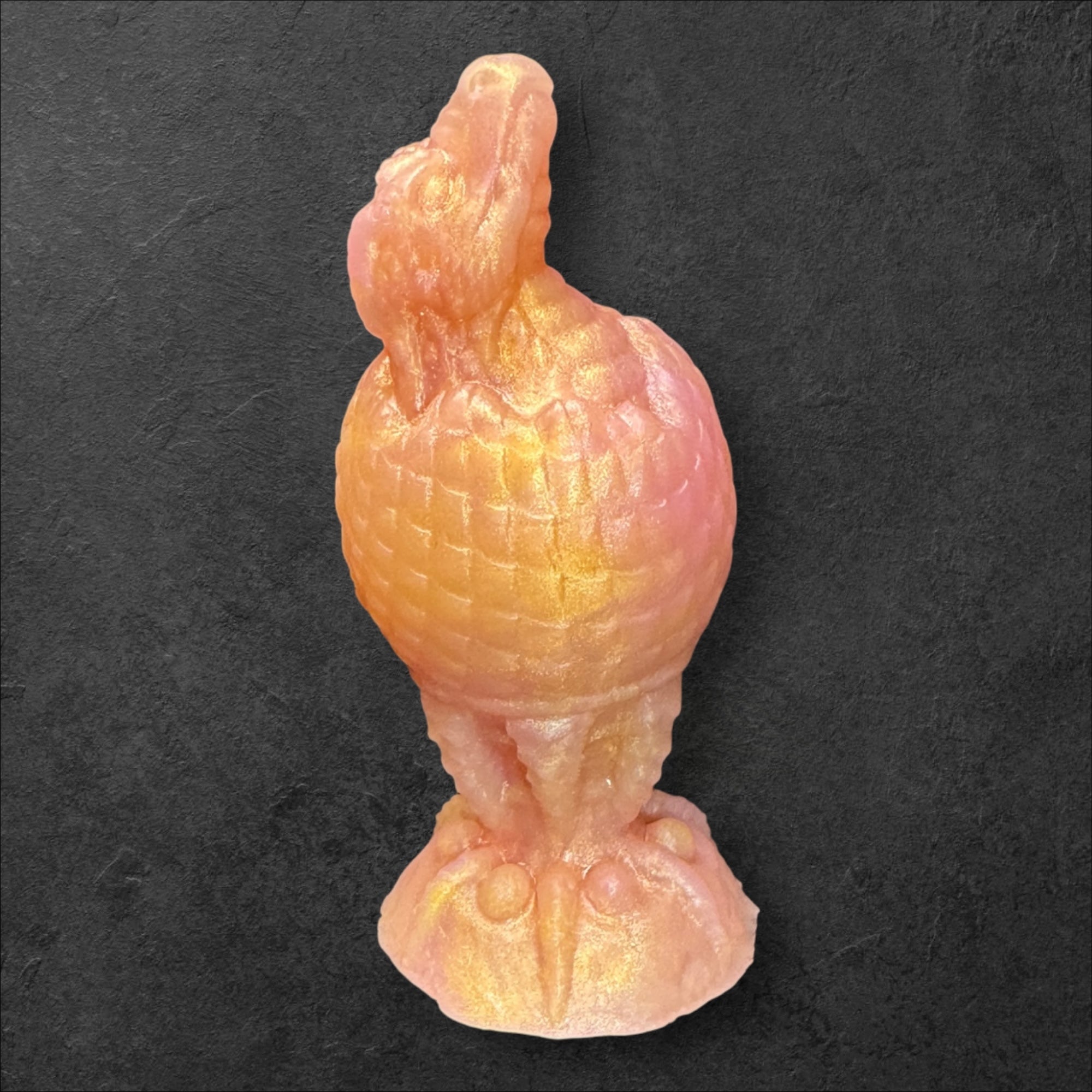 The Fire Egg Fantasy Plug. Textured dragon egg with hatching head at the tip and sculpted dragon claw safety base. Platinum Silicone by ClimaxLab.