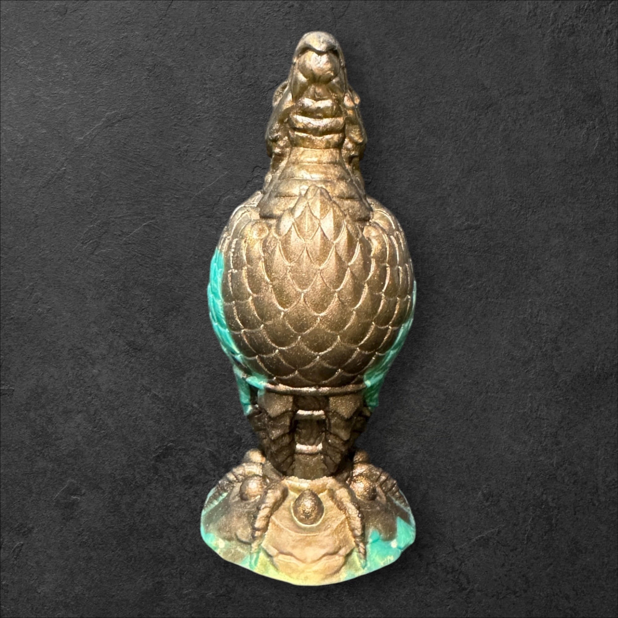 The Fire Egg Fantasy Plug. Textured dragon egg with hatching head at the tip and sculpted dragon claw safety base. Platinum Silicone by ClimaxLab.