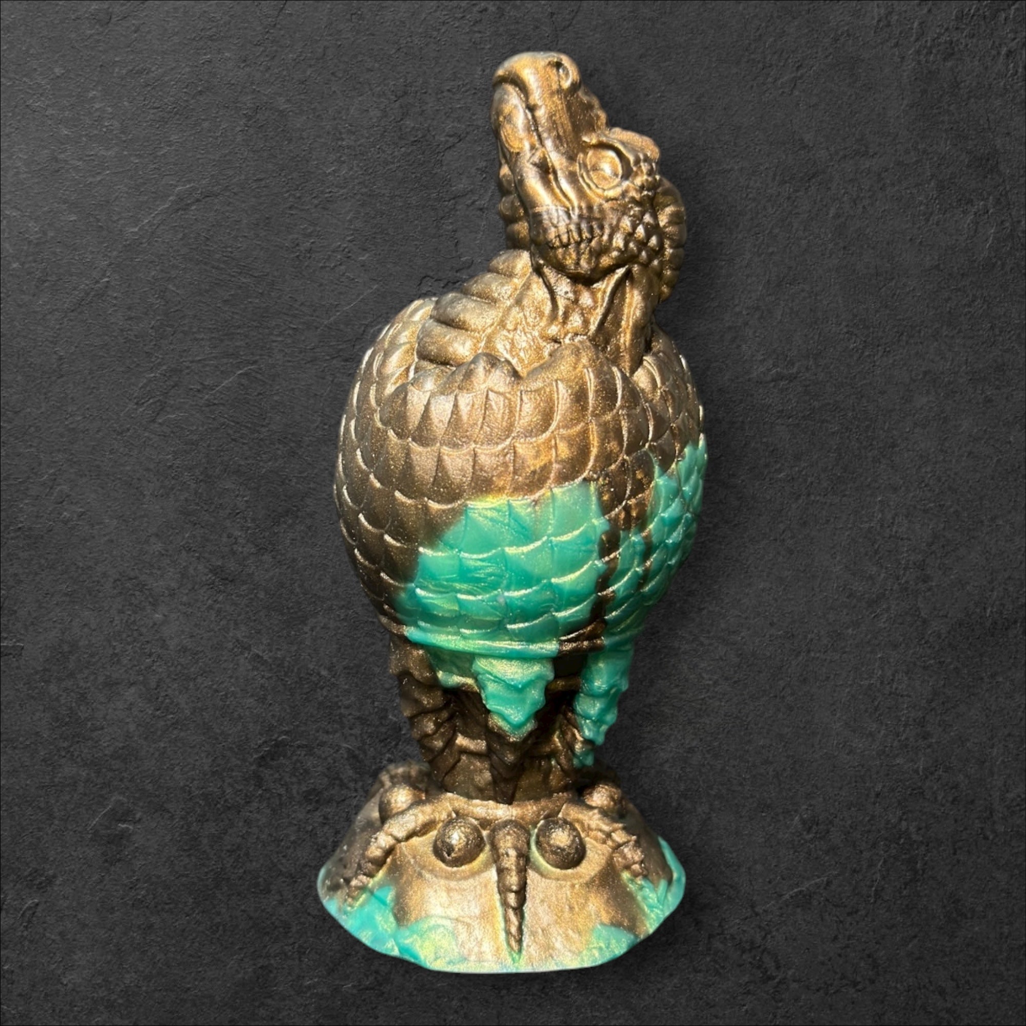 The Fire Egg Fantasy Plug. Textured dragon egg with hatching head at the tip and sculpted dragon claw safety base. Platinum Silicone by ClimaxLab.