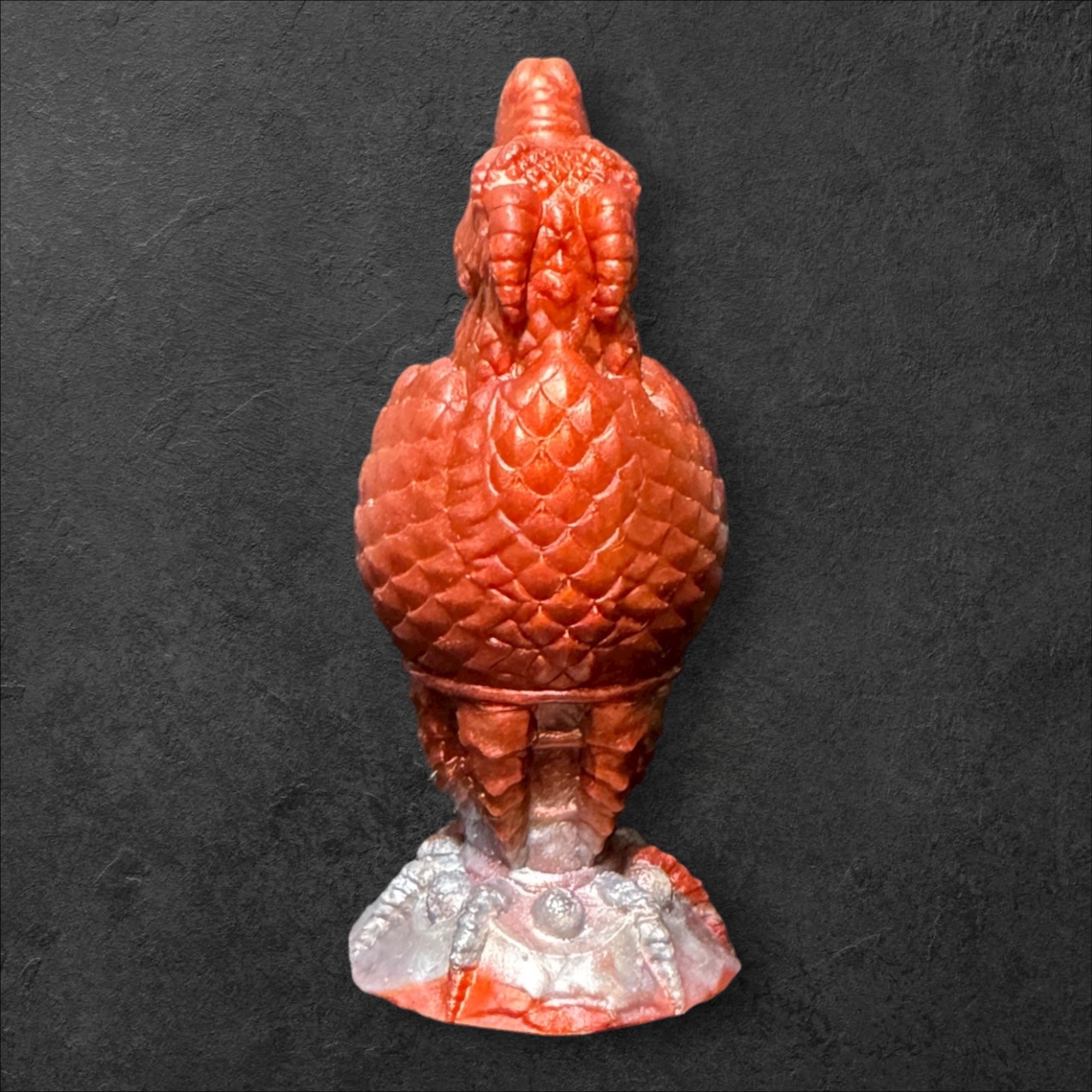 The Fire Egg Fantasy Plug. Textured dragon egg with hatching head at the tip and sculpted dragon claw safety base. Platinum Silicone by ClimaxLab.