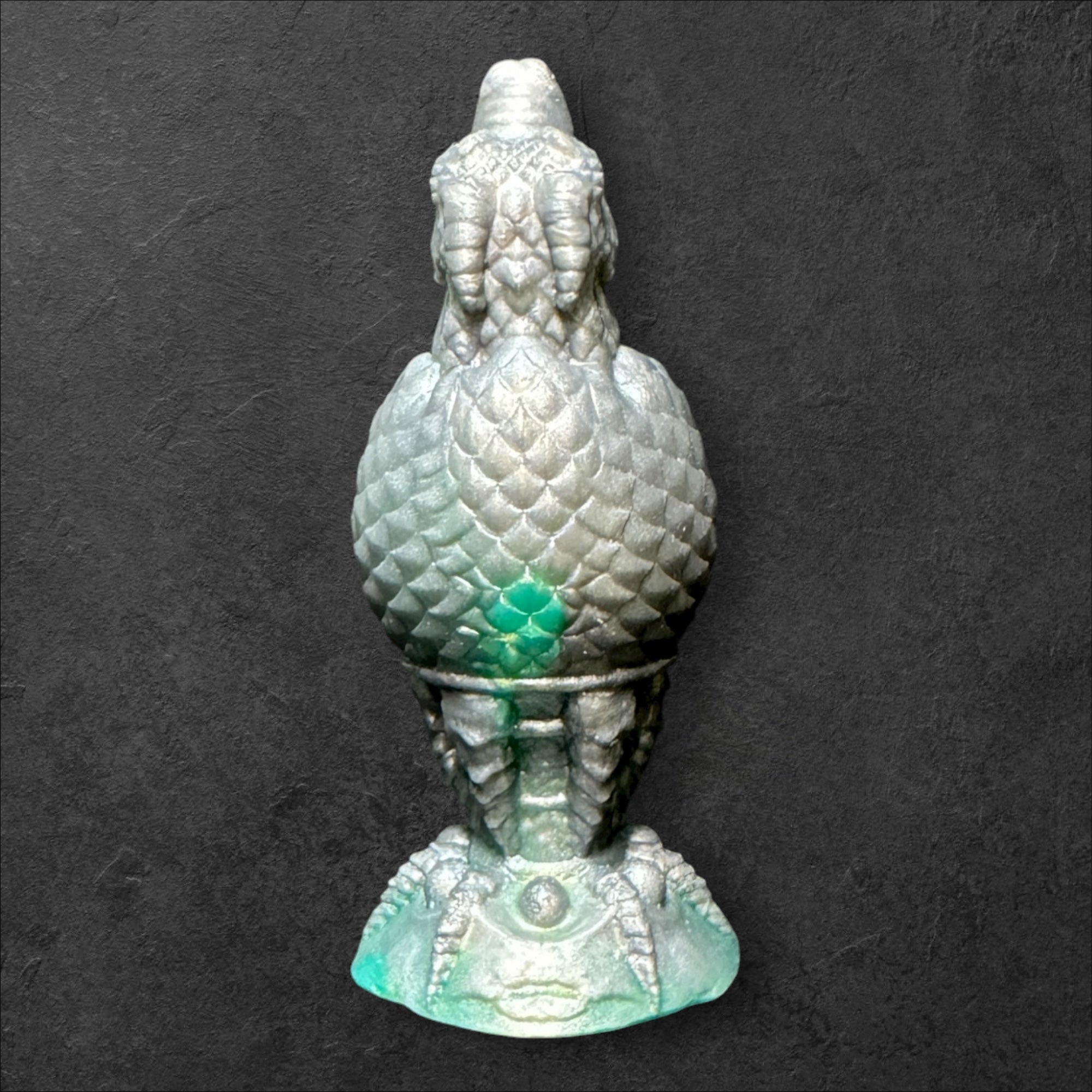 The Fire Egg Fantasy Plug. Textured dragon egg with hatching head at the tip and sculpted dragon claw safety base. Platinum Silicone by ClimaxLab.