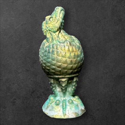 The Fire Egg Fantasy Plug. Textured dragon egg with hatching head at the tip and sculpted dragon claw safety base. Platinum Silicone by ClimaxLab.