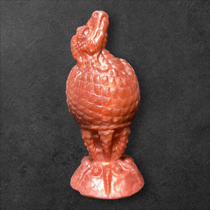 The Fire Egg Fantasy Plug. Textured dragon egg with hatching head at the tip and sculpted dragon claw safety base. Platinum Silicone by ClimaxLab.