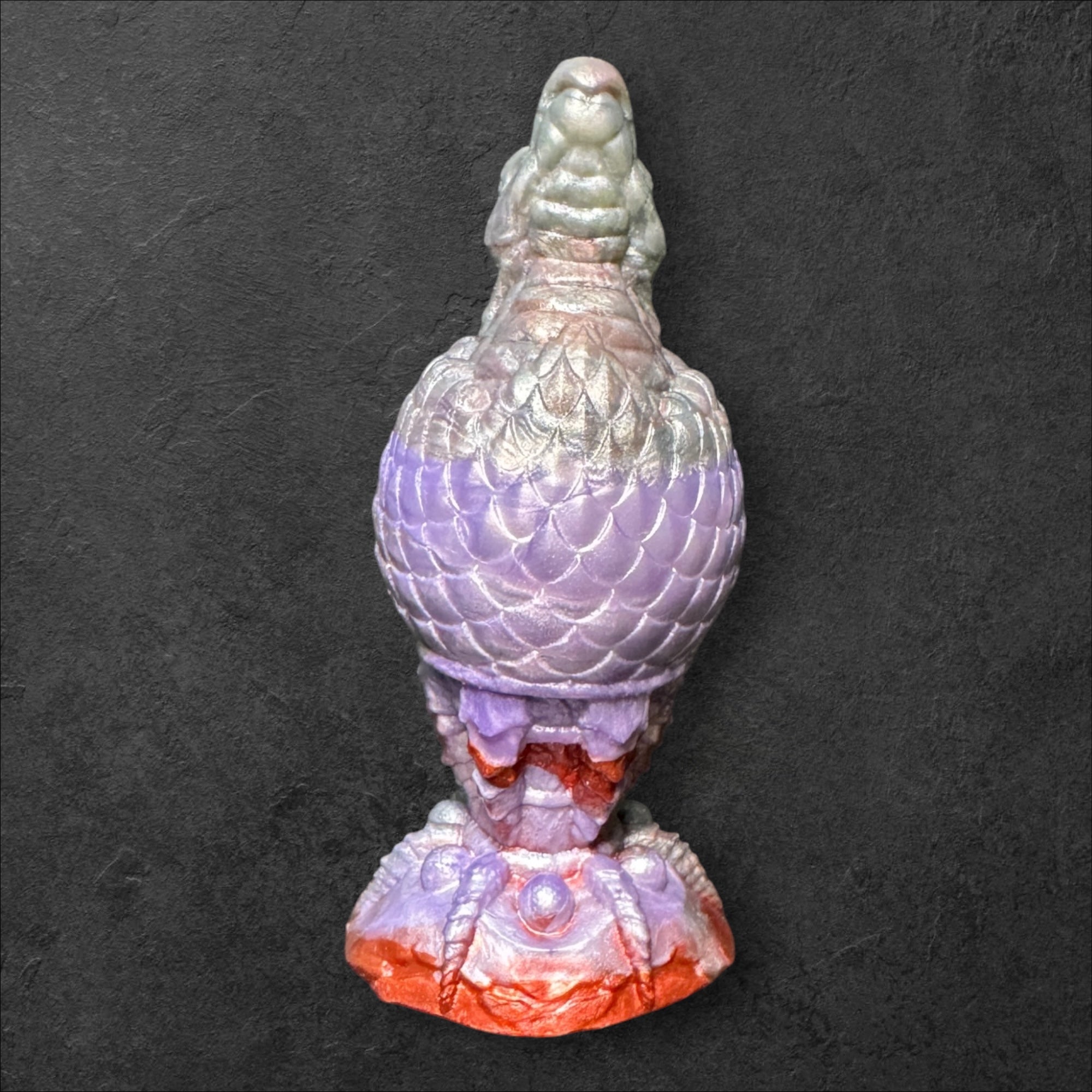 The Fire Egg Fantasy Plug. Textured dragon egg with hatching head at the tip and sculpted dragon claw safety base. Platinum Silicone by ClimaxLab.