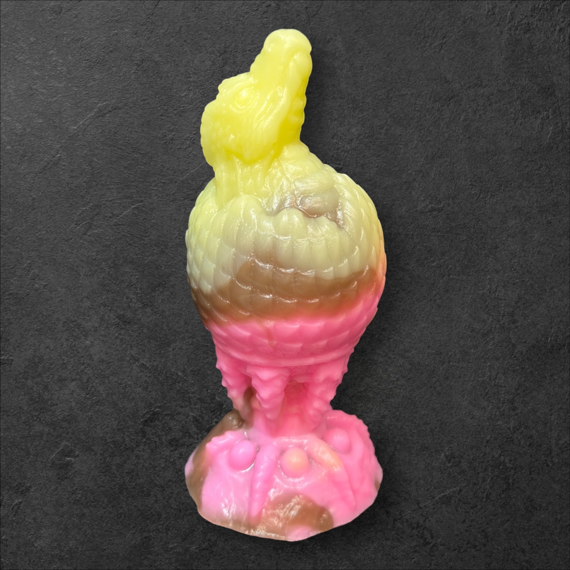 The Fire Egg Fantasy Plug. Textured dragon egg with hatching head at the tip and sculpted dragon claw safety base. Platinum Silicone by ClimaxLab.