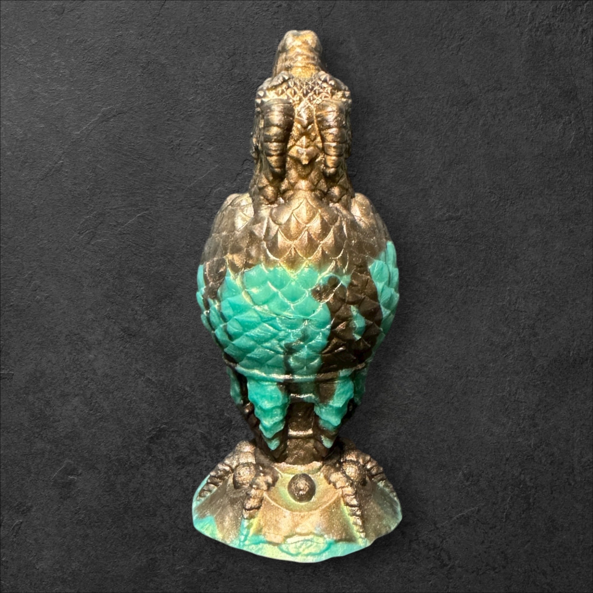 The Fire Egg Fantasy Plug. Textured dragon egg with hatching head at the tip and sculpted dragon claw safety base. Platinum Silicone by ClimaxLab.