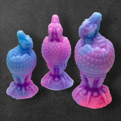 The Fire Egg Fantasy Plug. Textured dragon egg with hatching head at the tip and sculpted dragon claw safety base. Platinum Silicone by ClimaxLab.